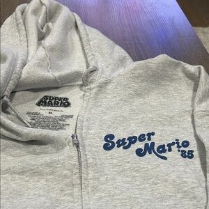 Nintendo Super Mario '85 Light Gray Zip-Up Hoodie with Blue Logo